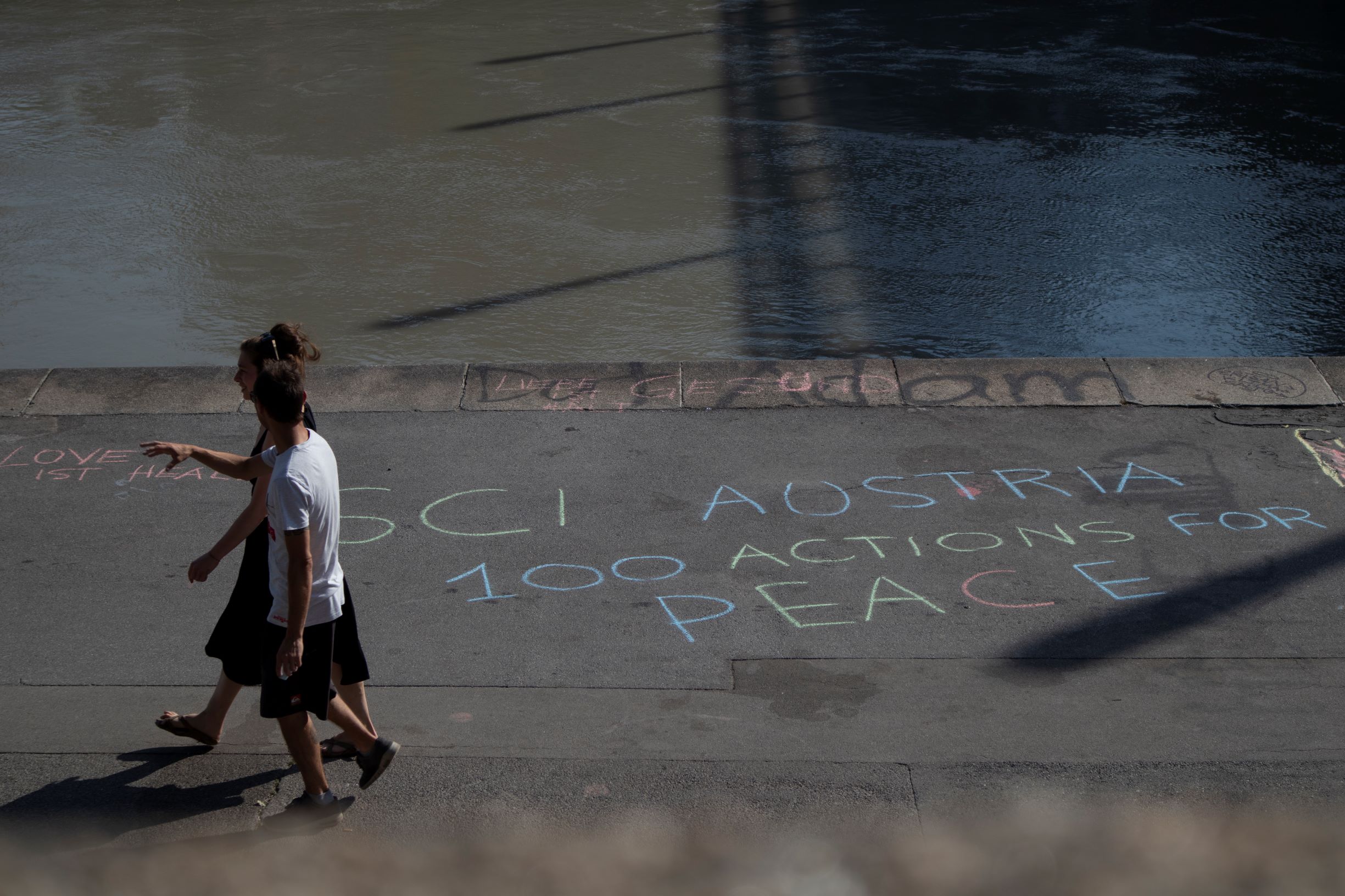 two people walking by the river