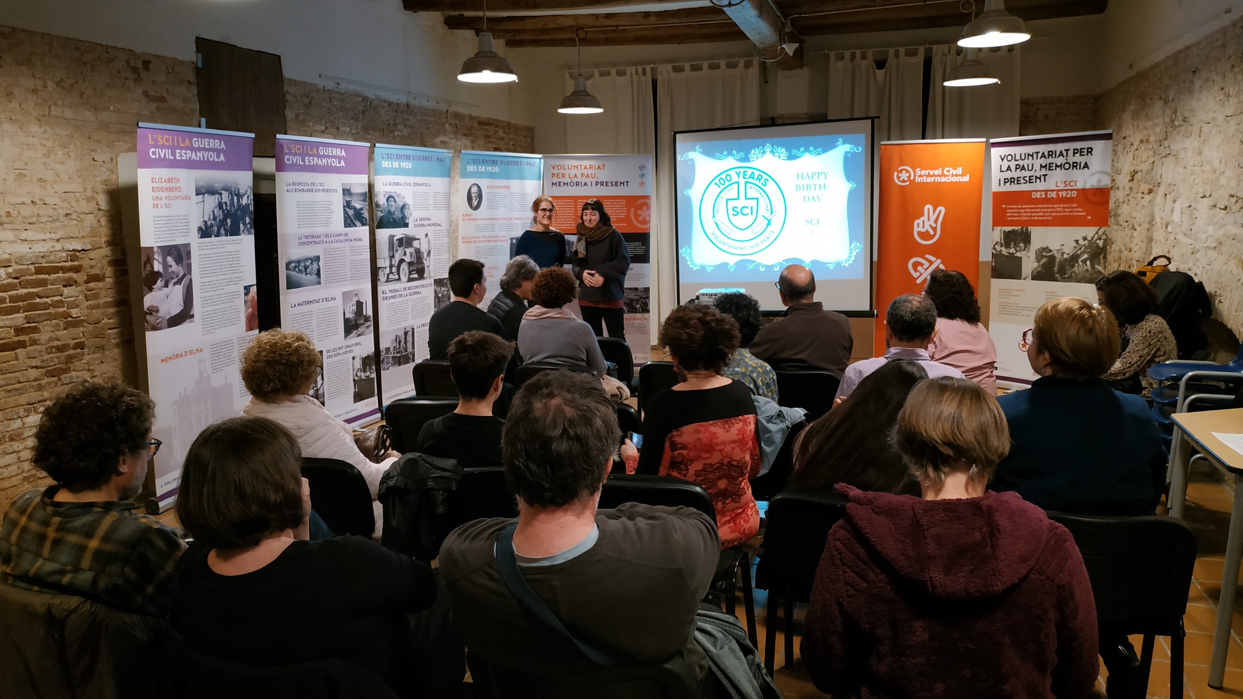 group of people listenning to a presentation