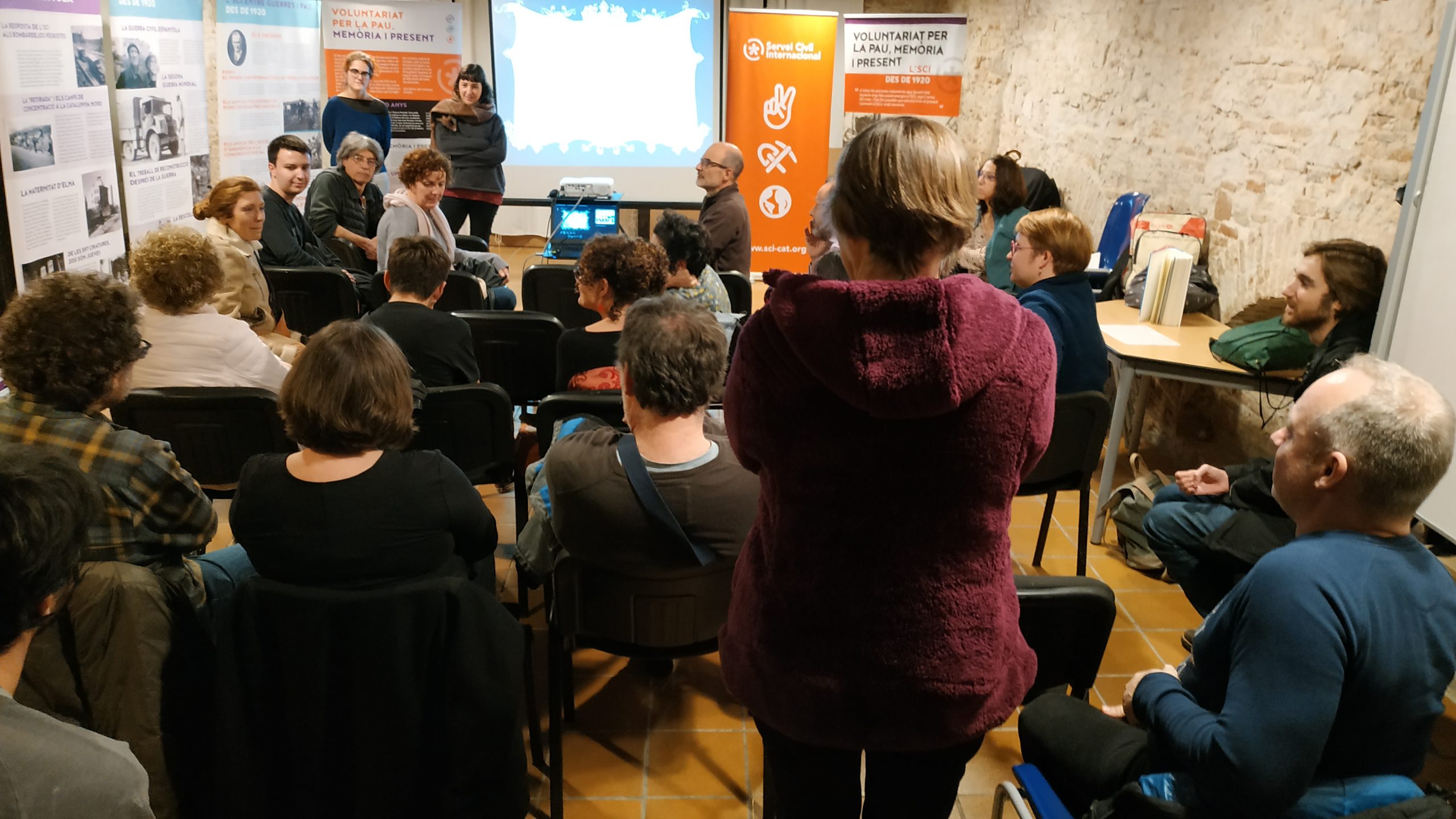 group of people listenning to a presentation